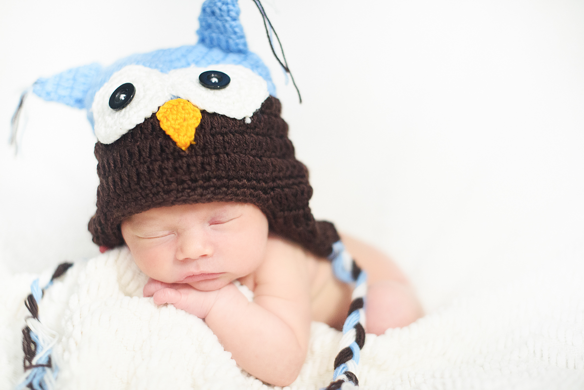 Baby boy wearing a knitted owl hat by Greenville SC Newborn Photographer Elizabeth and Charles.